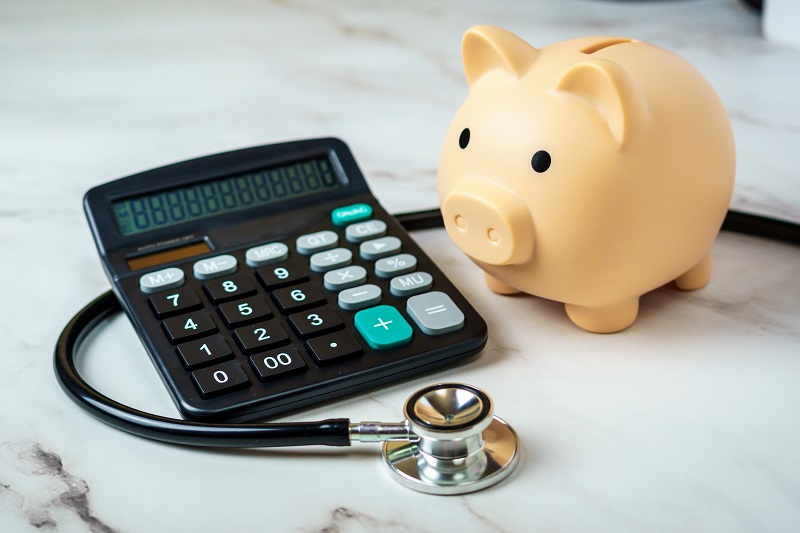 Piggy Bank and Calculator on a Medical Stethoscope